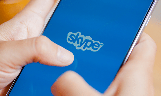 A person on their phone using Skype