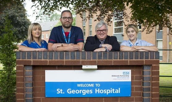 Hospital staff pose outside St George's Hospital, now part of Midlands Partnership NHS Foundation Trust