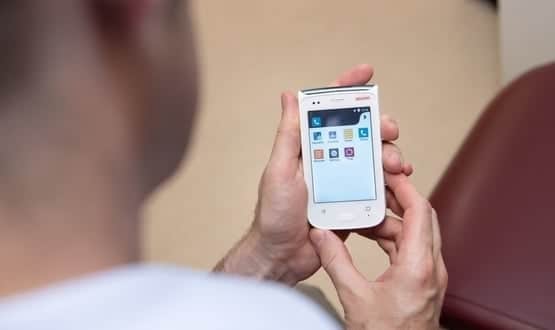 A nurse uses Ascom's Myco smartphone at Royal Bolton Hospital