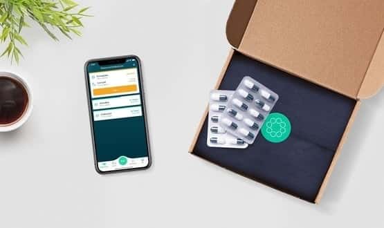 A smartphone displaying the Echo app next to a box of medication