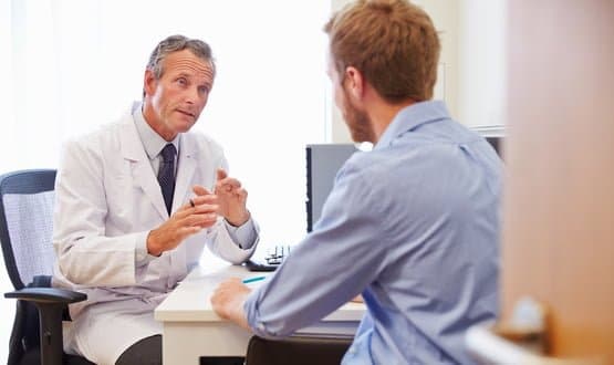 A doctors speaks with a patient in a GP pratice