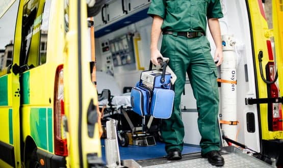 A paramedic stepping out of an ambulance