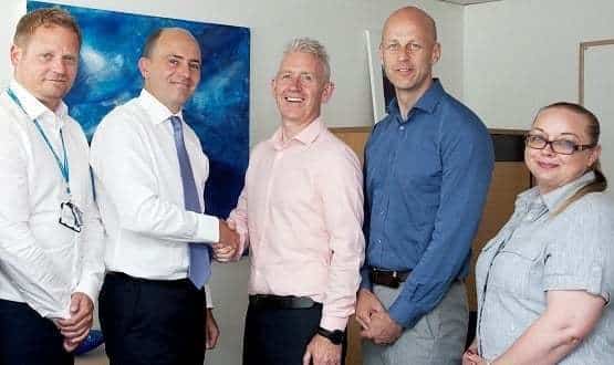 Pictured (L-R) during contract signing in 2018 are Ian Hooper, Director of Procurement; Supply Chain, and Roland Sinker, CEO, at Cambridge University Hospitals with Novosco’s Strategic Advisor Patrick McAliskey, Managing Director John Lennon, and Client Director Ellen Dickson.